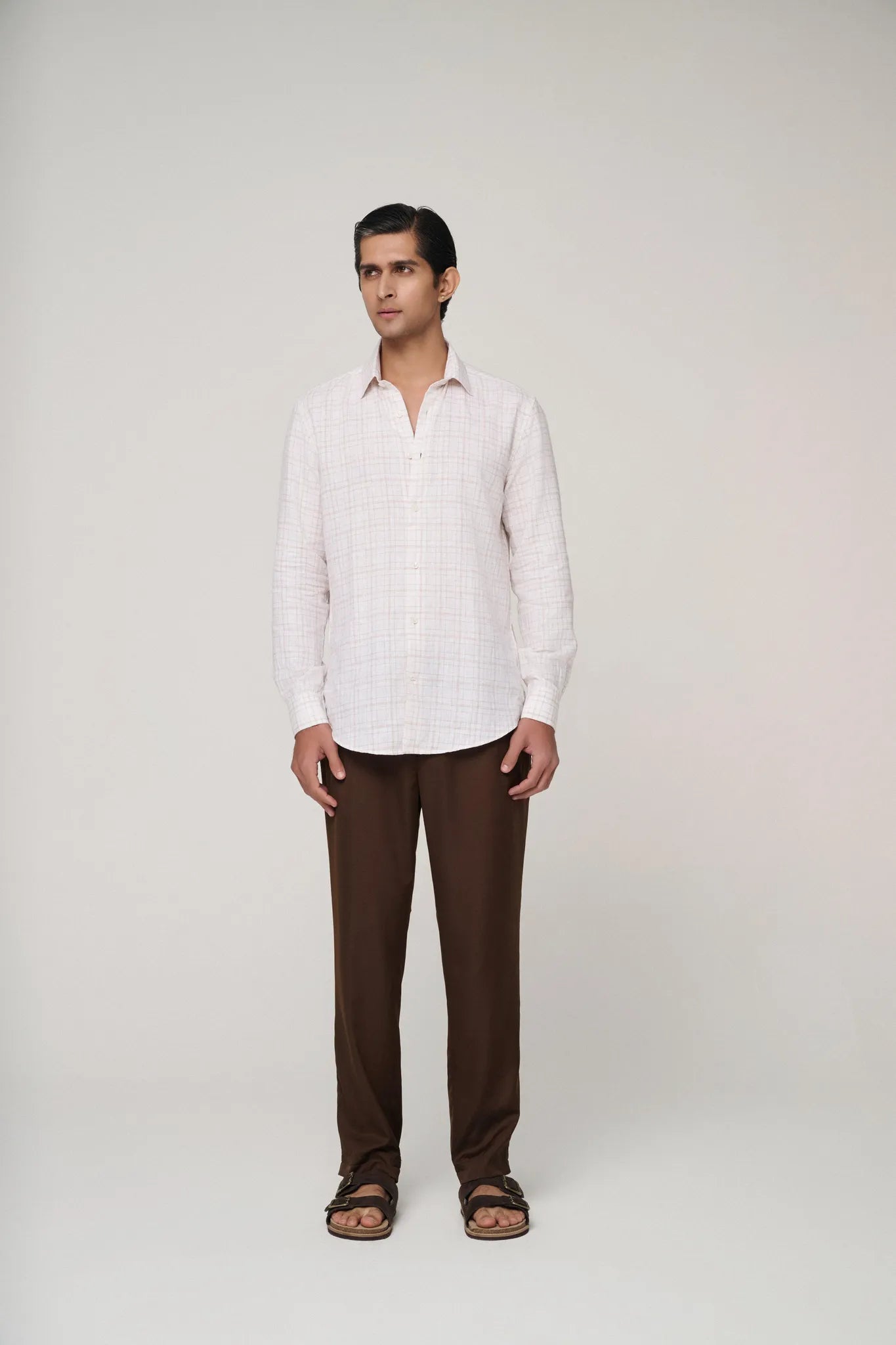 confident look with pink check linen shirt front view.