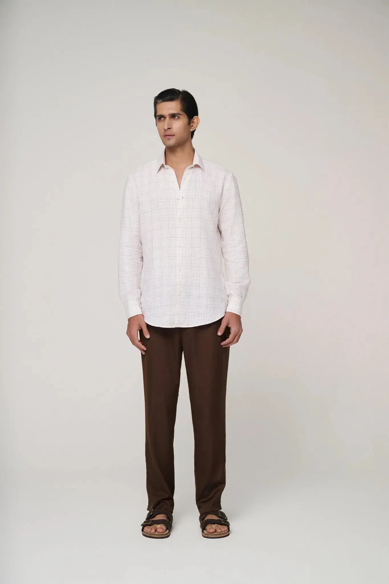 confident look with pink check linen shirt front view.