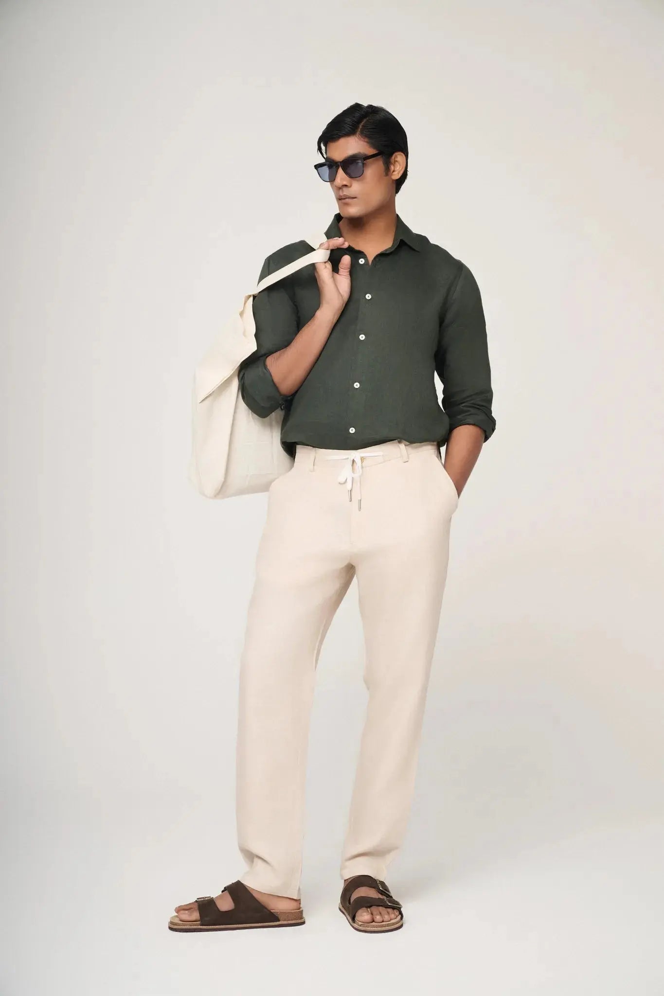 green linen shirt styled with cream trousers