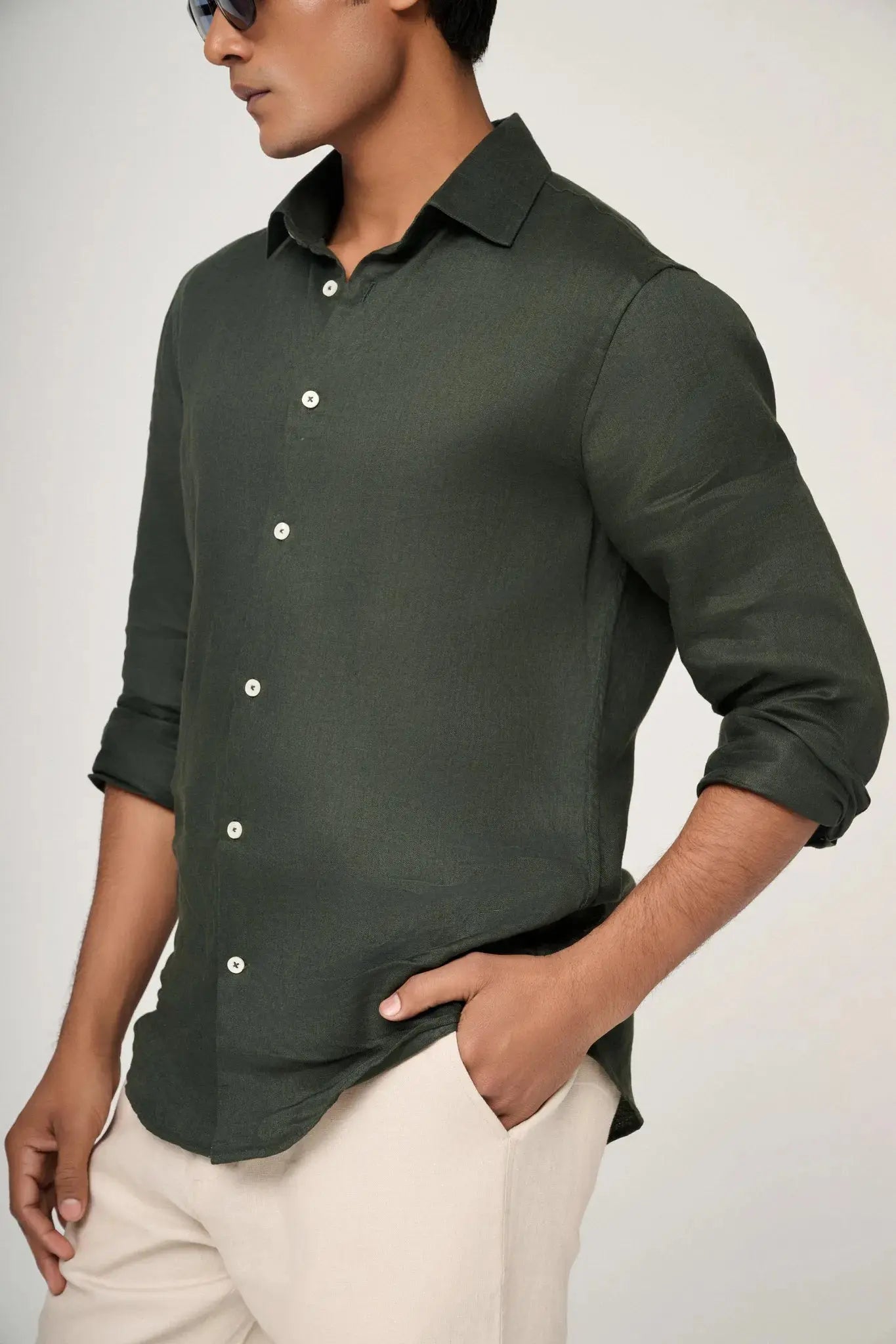 sleeve and fit detail on green linen shirt