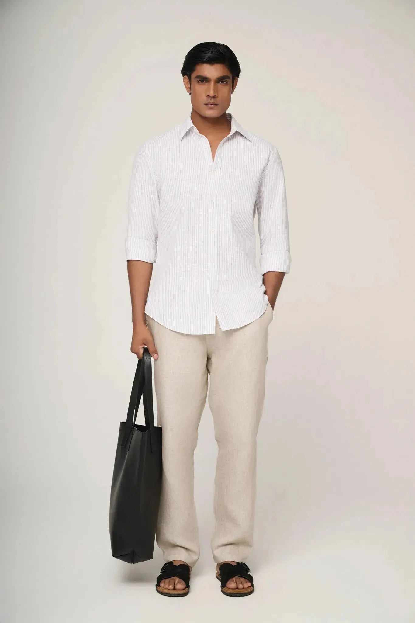 Model wearing blue striped linen shirt.