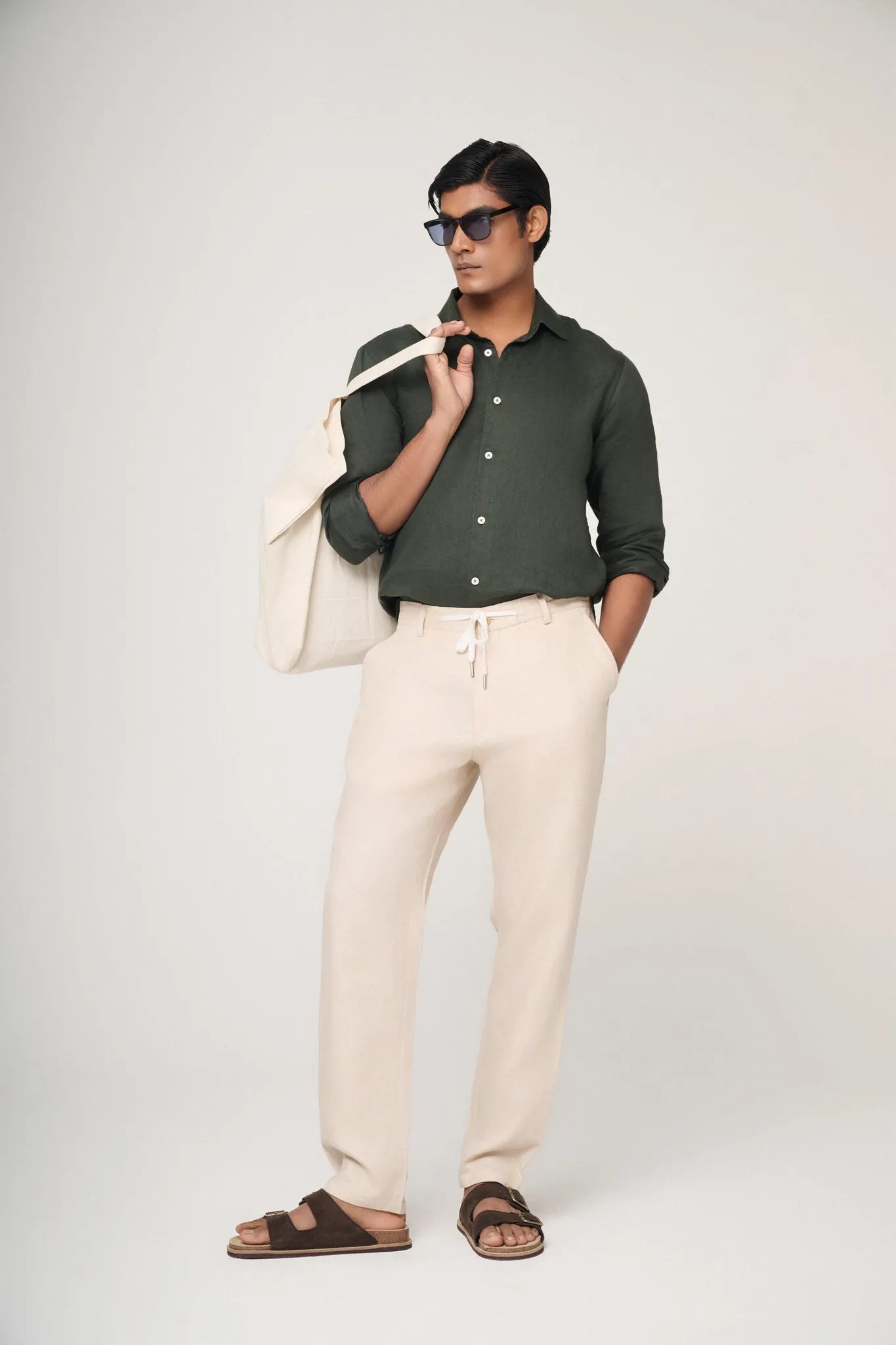 green linen shirt styled with cream trousers