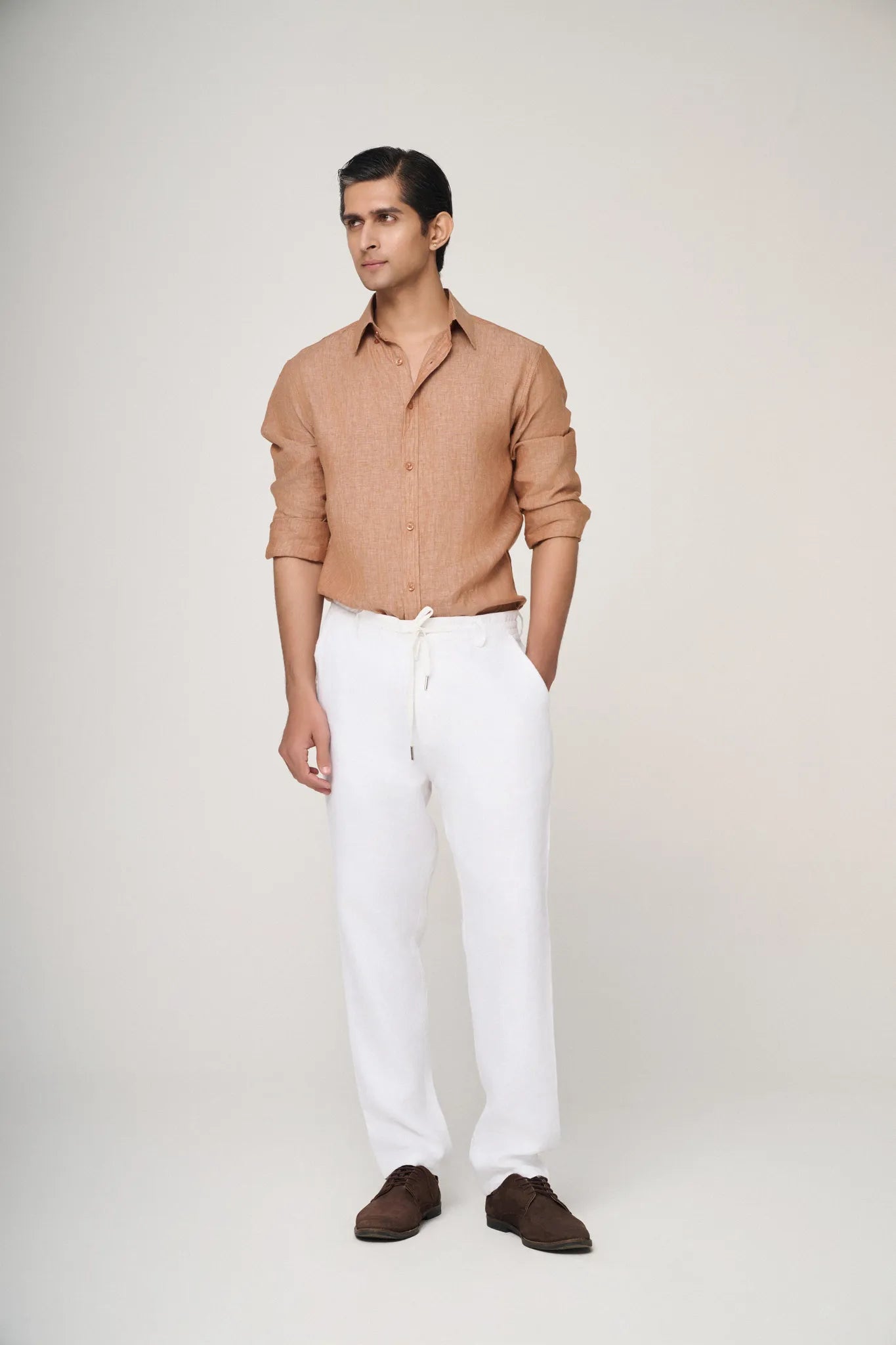 light brown linen shirt paired with white chinos.