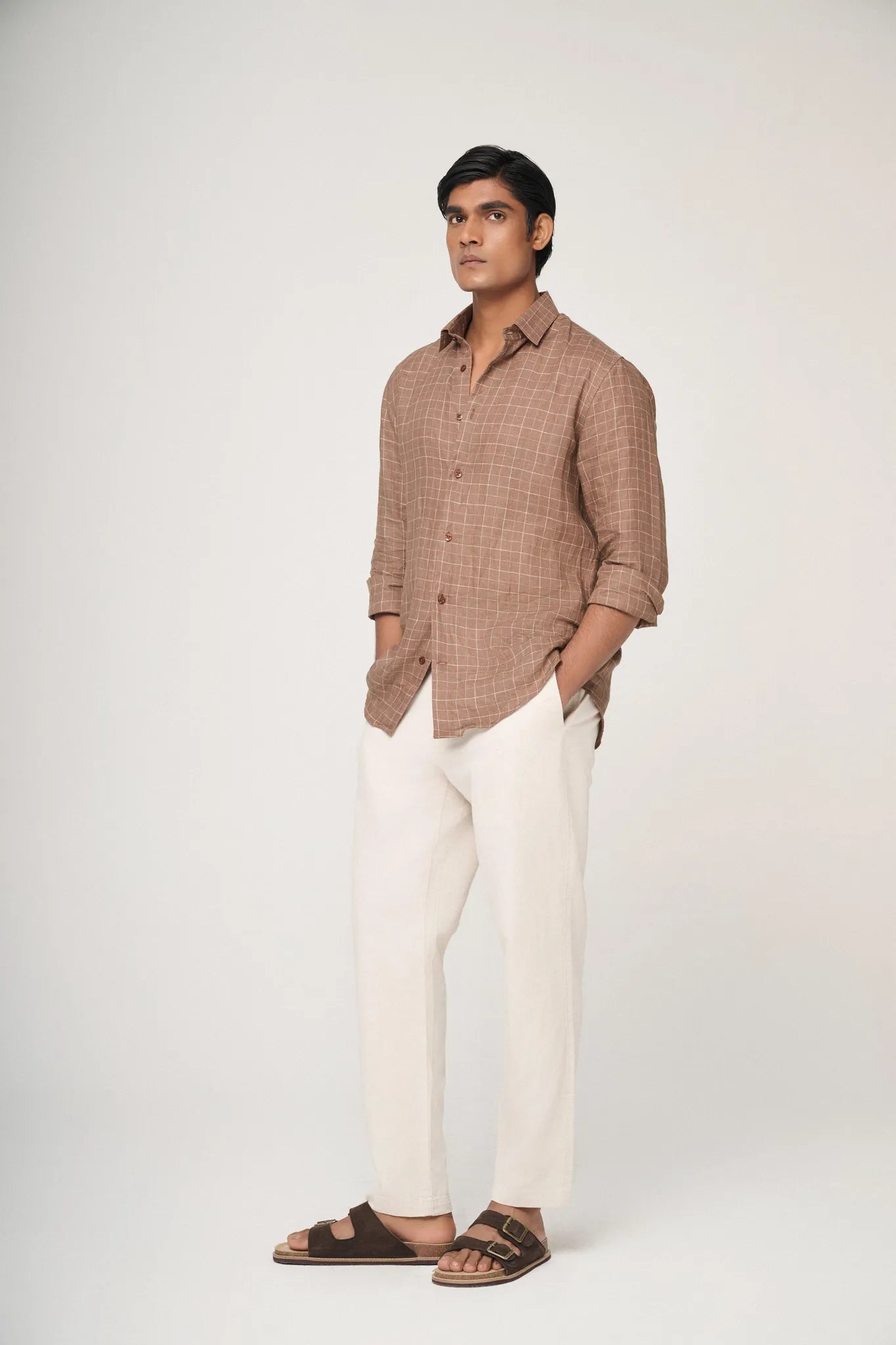 Side profile of model in Brown checked linen shirt, showcasing fit.