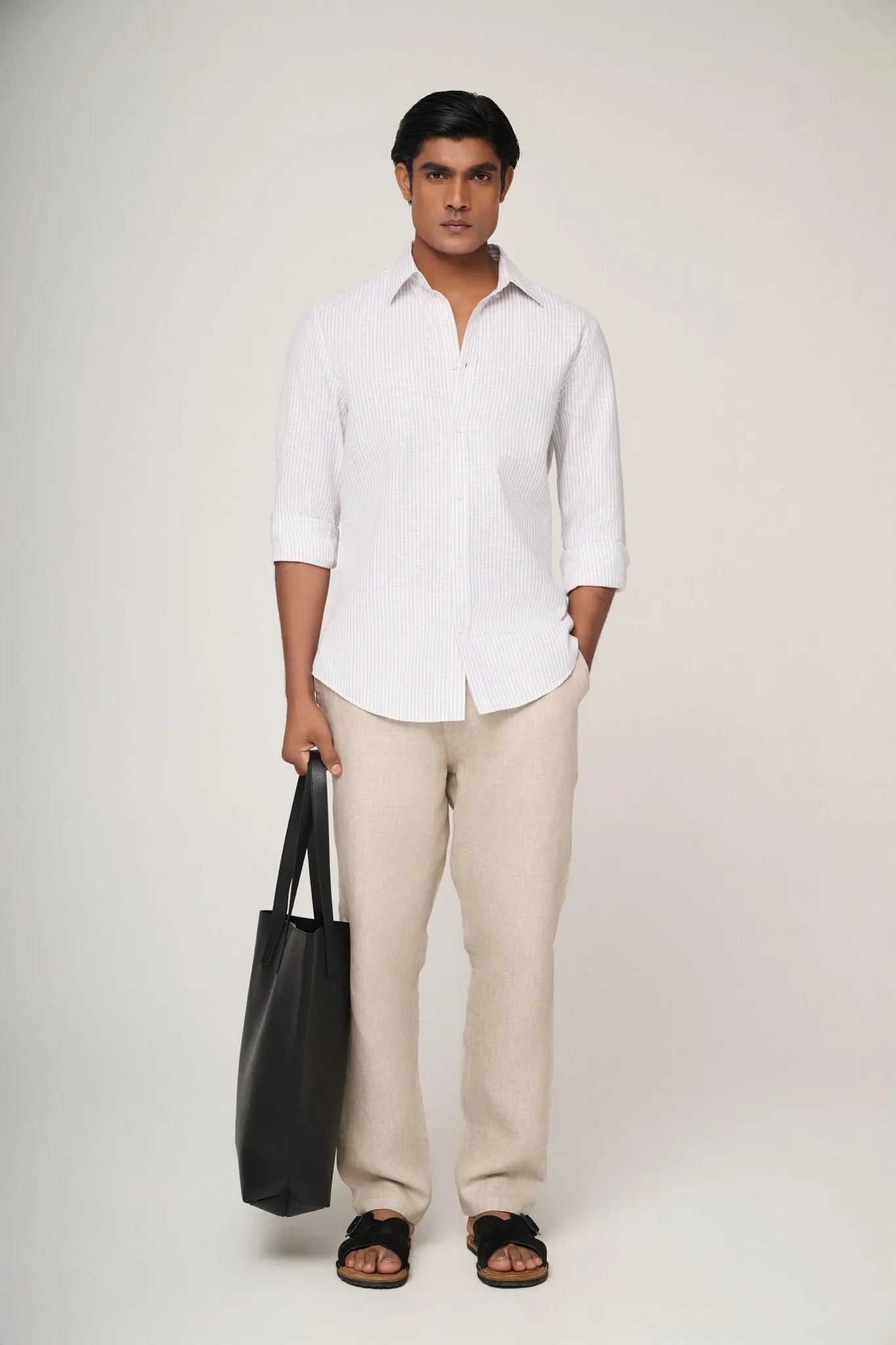 Model wearing blue striped linen shirt.